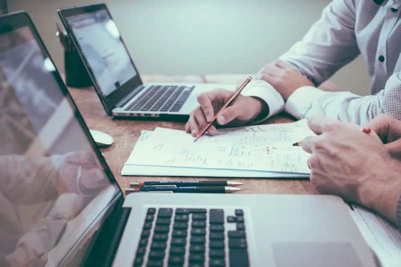 Business professional analyzing break-even data on laptop
